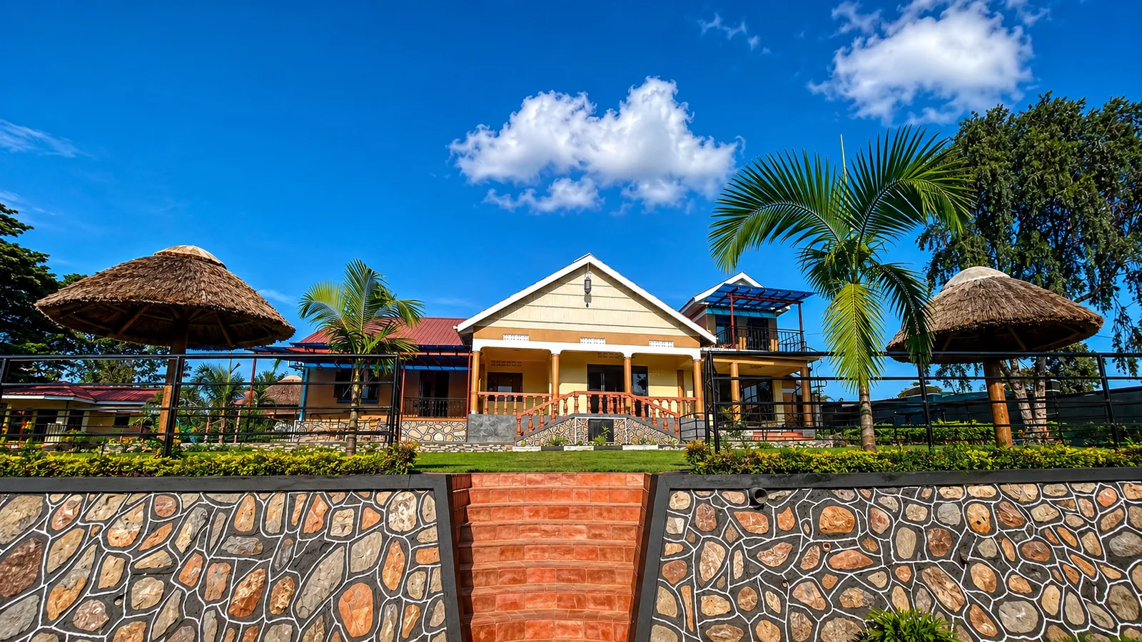 Main building and palm gardens at Tooro Resort
